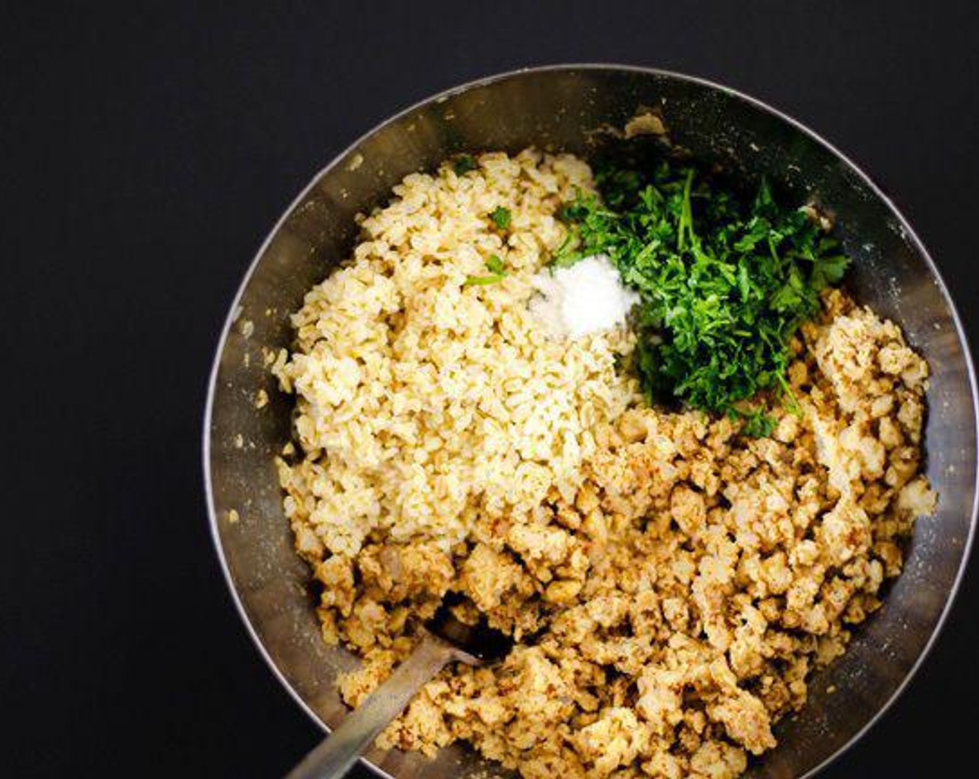 step 2 While bulgur is doing its thing, combine Canned Chickpeas (1 1/2 cups), Onion (1/2 cup), Garlic (2 cloves), Salt (1 tsp), Finely Ground Black Pepper (1/2 tsp) and Chili Powder (1 tsp) in a food processor until it holds together in a dough. Don’t over do it though, we don’t want hummus! If dough seems overly wet and sticks to your hands, add flour one tablespoon at a time.