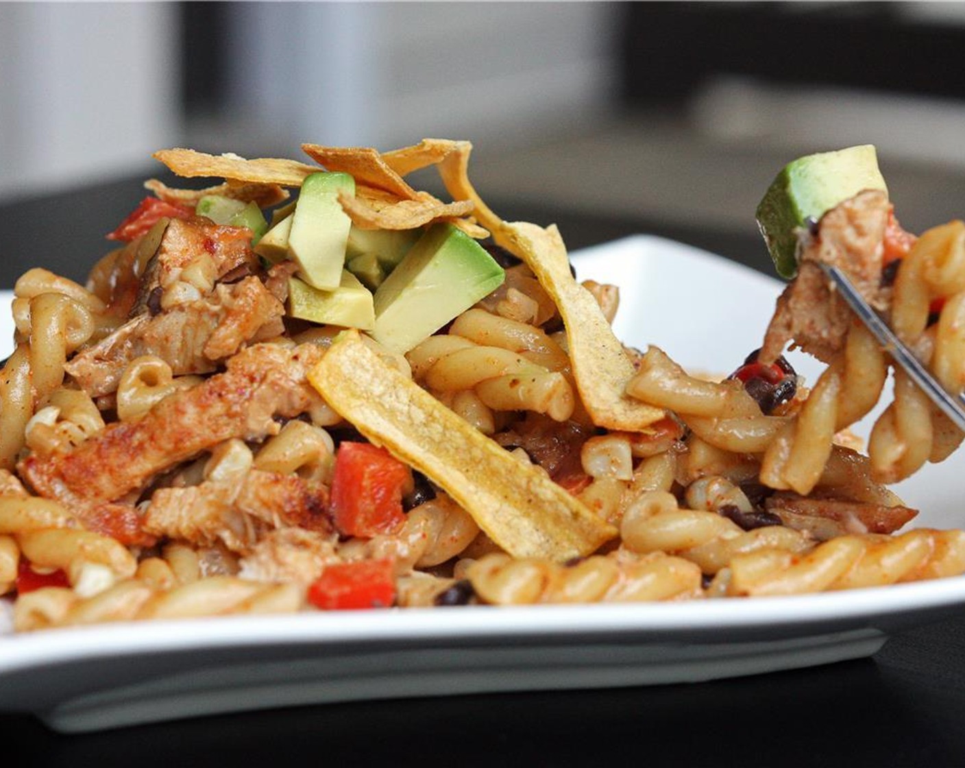 step 10 Drain pasta and add to the sauce mixture. Add the chicken and mix well until all pasta is coated. Serve sprinkled with crisp tortilla strips and a few chunks of avocado.