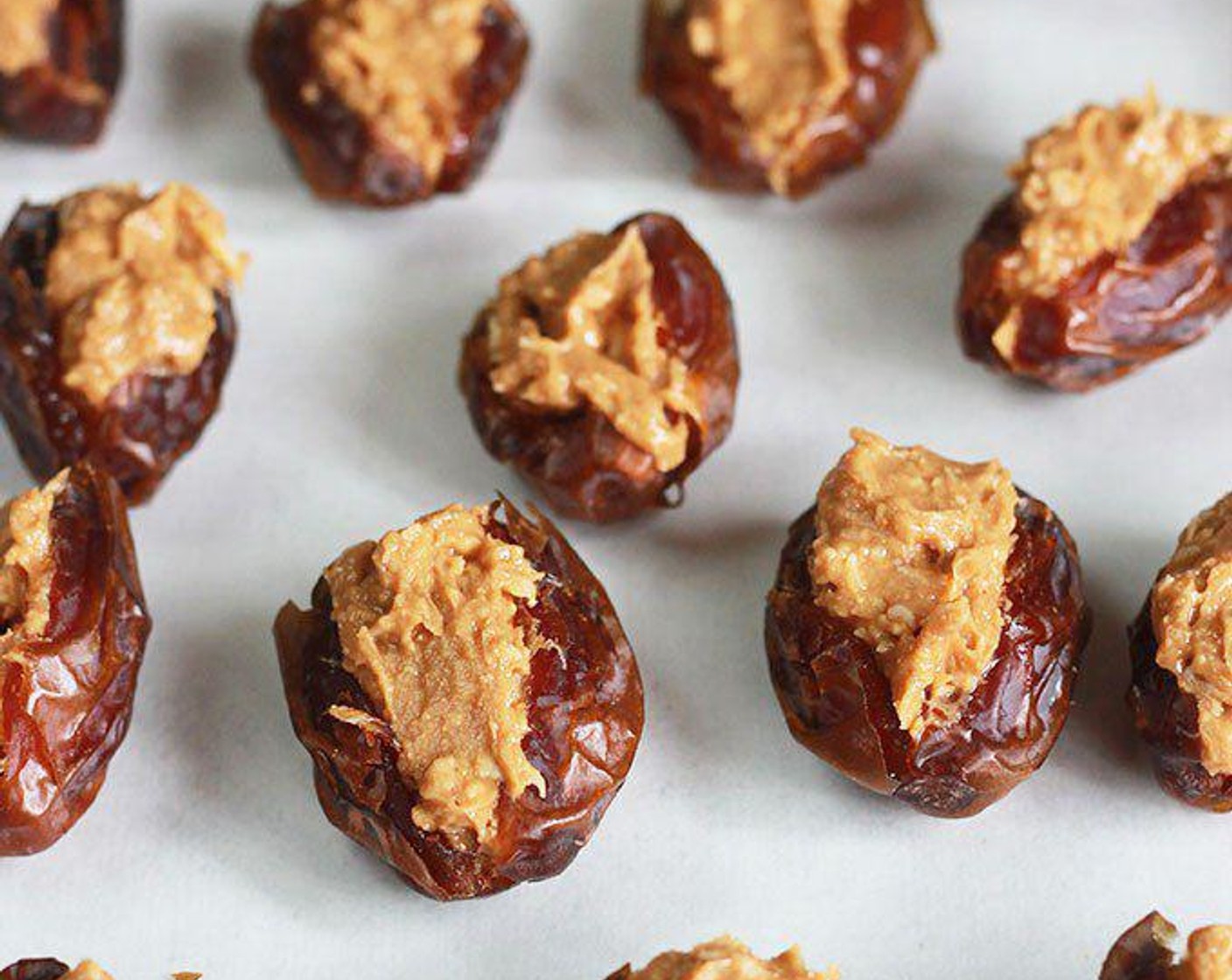 step 2 With clean hands, open one side of the Dates (25) and carefully remove the pits. Gently fill dates with 1-1 1/2 teaspoons of the nut butter mixture and place on a parchment-lined baking sheet.