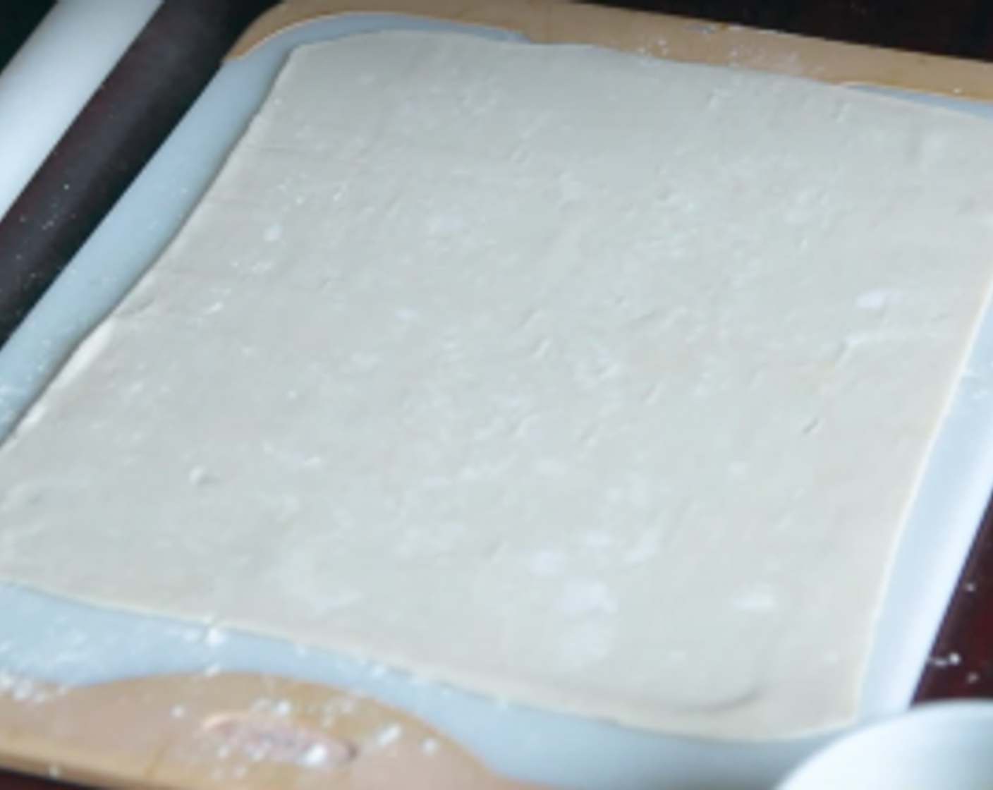 step 6 Put All-Purpose Flour (to taste) on a clean surface and roll out the puff pastry to lengthwise, so it becomes longer. Cut into 6 long strips and brush with the Apricot Jam (1 Tbsp).