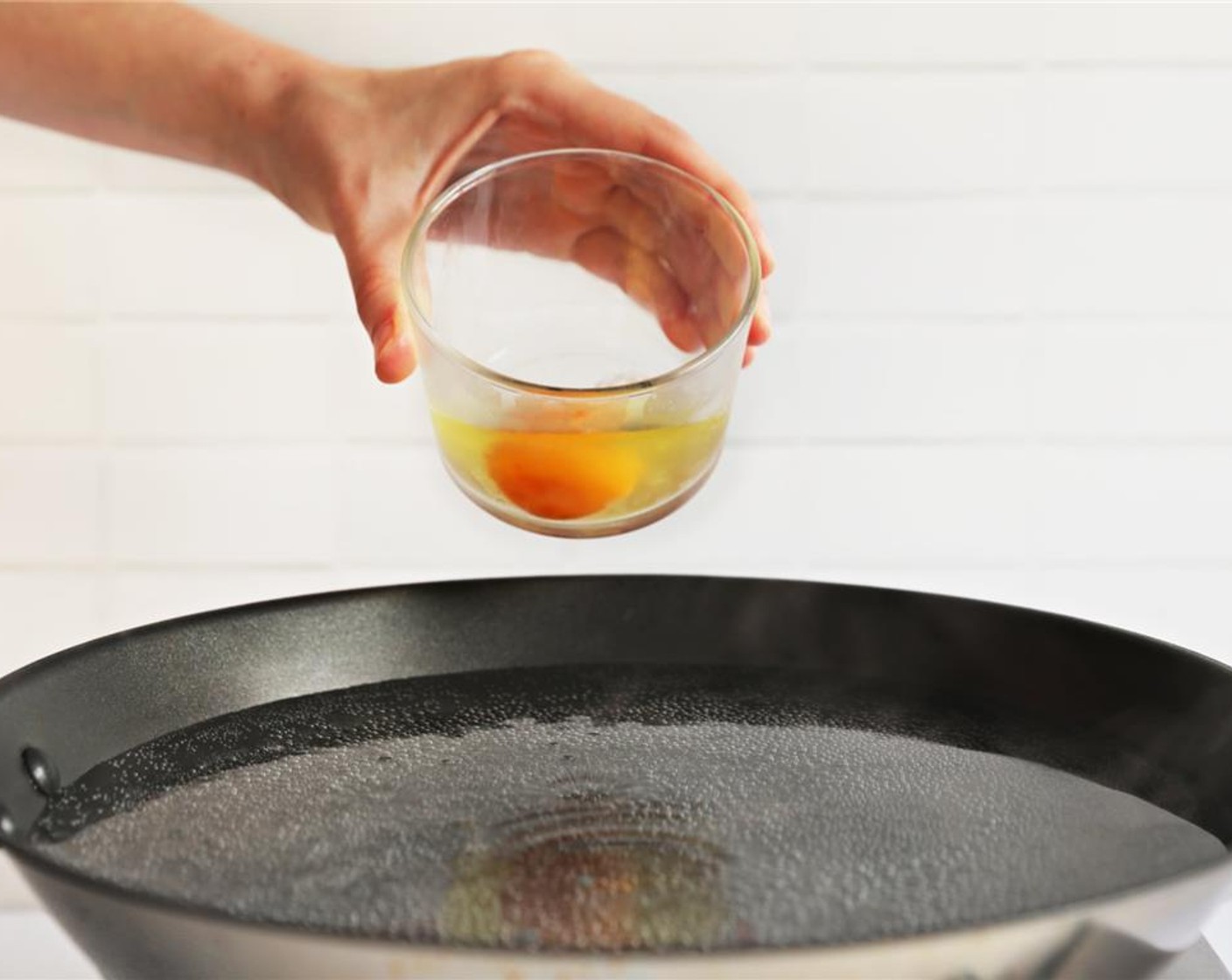 step 4 Crack an Egg (1) into a small bowl and gently slide into the pan.