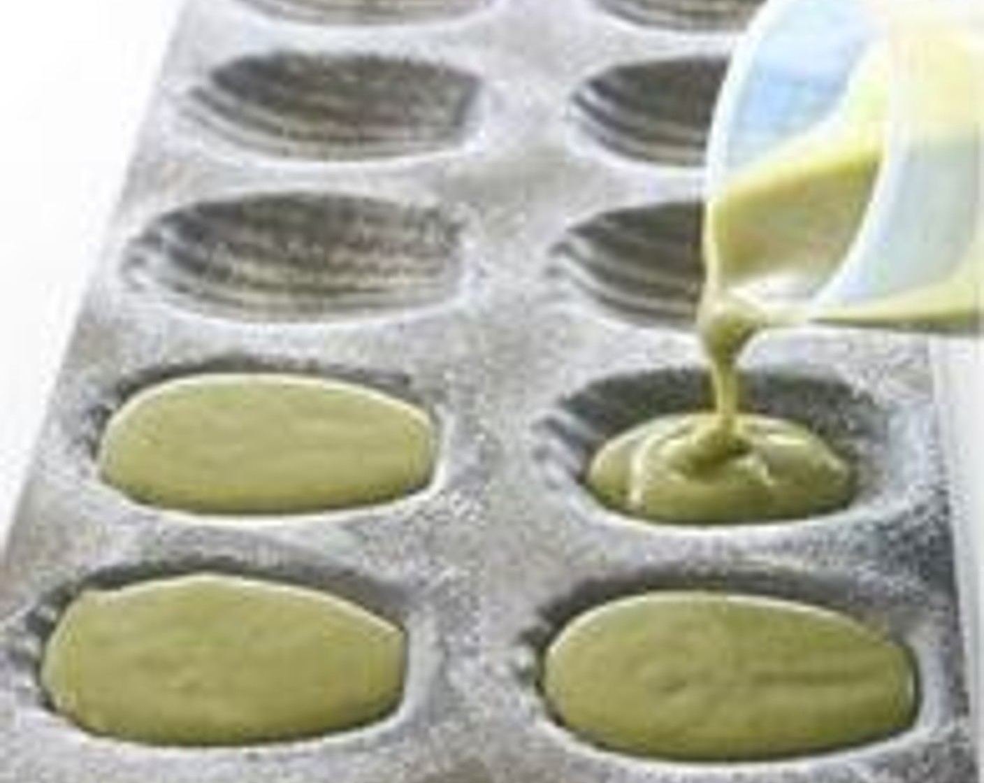 step 5 Pour matcha batter in madeleine pan (grease pan with butter and dust with flour) to almost full.