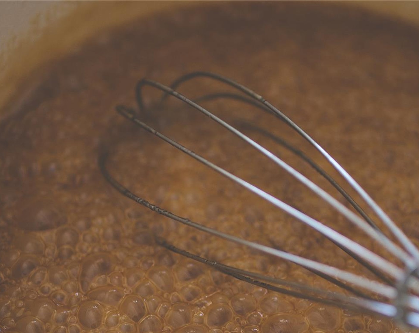 step 8 Now, in a heavy bottomed soup pot, add the bowl of caramel ingredients and heat over medium flame. Continuously stir until combined, then allow to cook until it's reached 350 degrees F (180 degrees C). It should boil, without stirring, until it's dark amber.