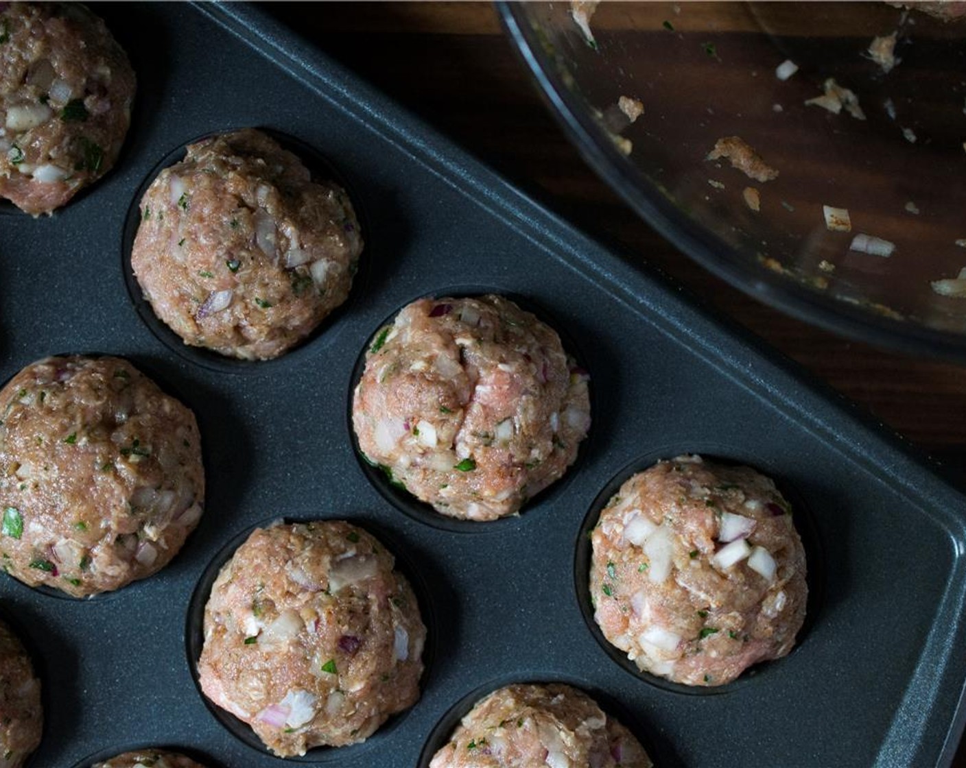 step 3 Roll meatballs a little bigger than the size of a golf ball. Place rolled meatballs in individual miniature muffin tins. If you do not have a miniature muffin tin, a sheet pan will work just fine, just move the meatballs around halfway through to ensure the bottoms are not burning. Bake for 20 minutes or until nicely browned and cooked through.