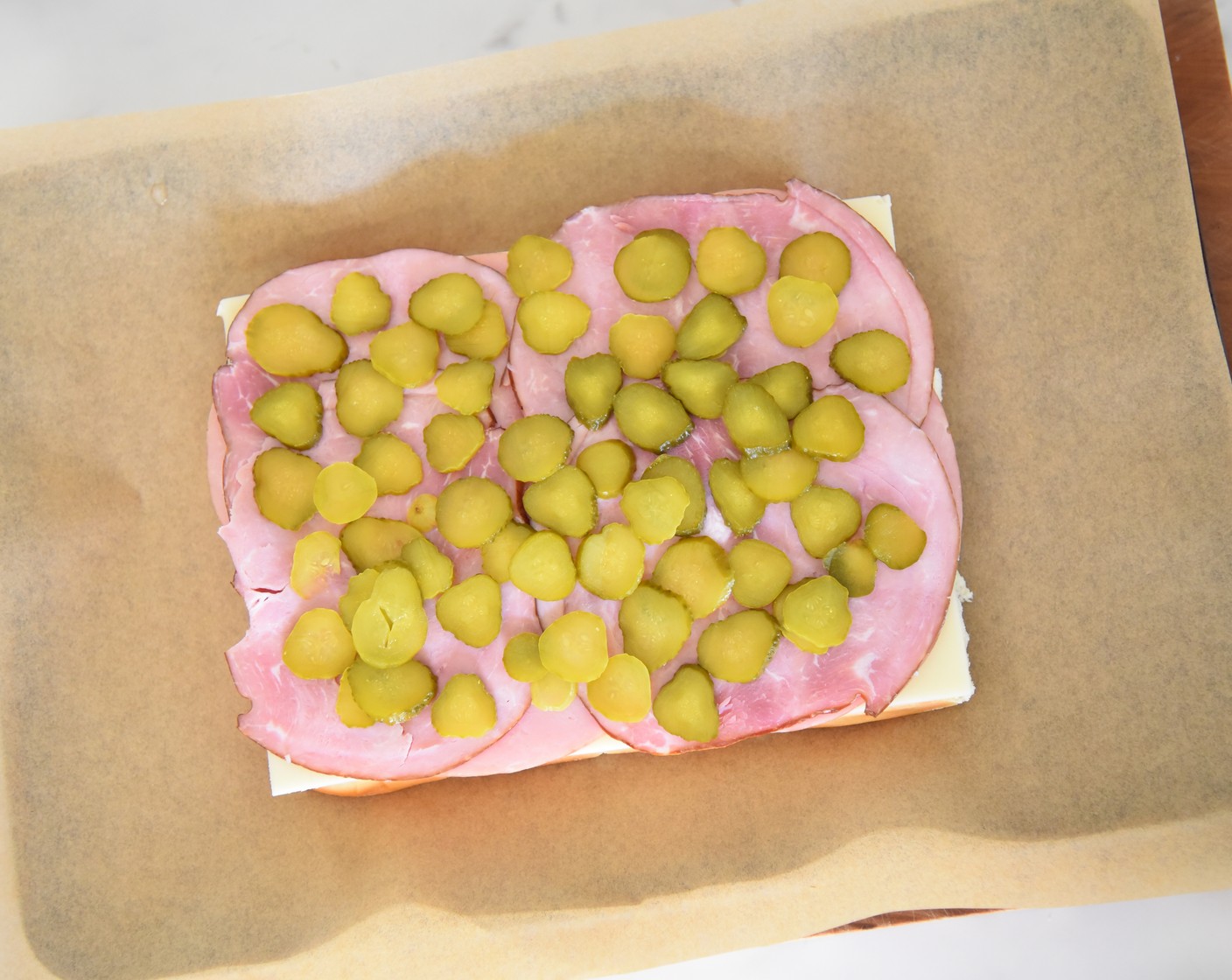 step 7 Evenly distribute the sliced pickle slices on top of the ham.