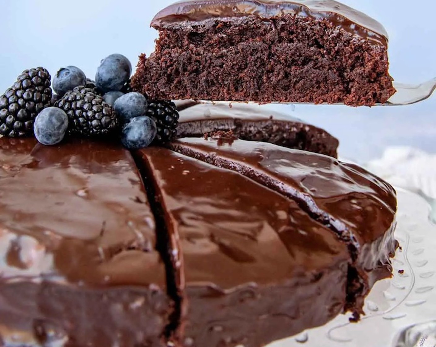 step 12 Transfer the cake to the refrigerator to set the ganache, for at least 15 minutes, then carefully remove the wax paper strips. Optionally, top with Whipped Cream (to taste) and Fresh Blueberries (to taste).