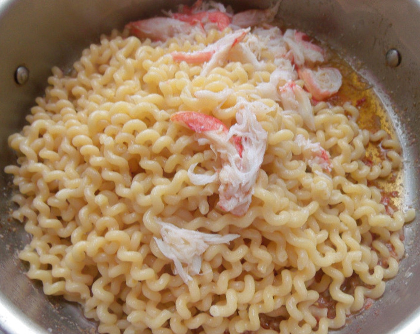 step 6 Add fusilli, season with kosher salt to taste, mix, check and adjust seasoning; serve garnished with the pieces of crab and finely sliced Scallions (to taste).