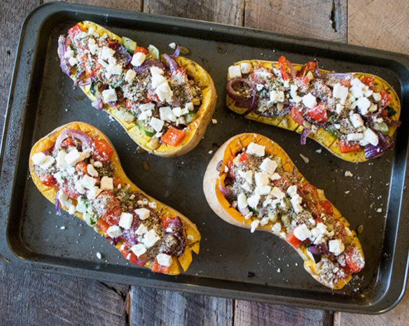 step 8 Arrange the roasted vegetables in the squash halves (if the holes are quite small arrange the vegetables on the flesh), sprinkle with the almond/cheese/flax mix, top with Feta Cheese (1/2 cup) and Fresh Herbs (to taste) and bake for another 10 minutes.