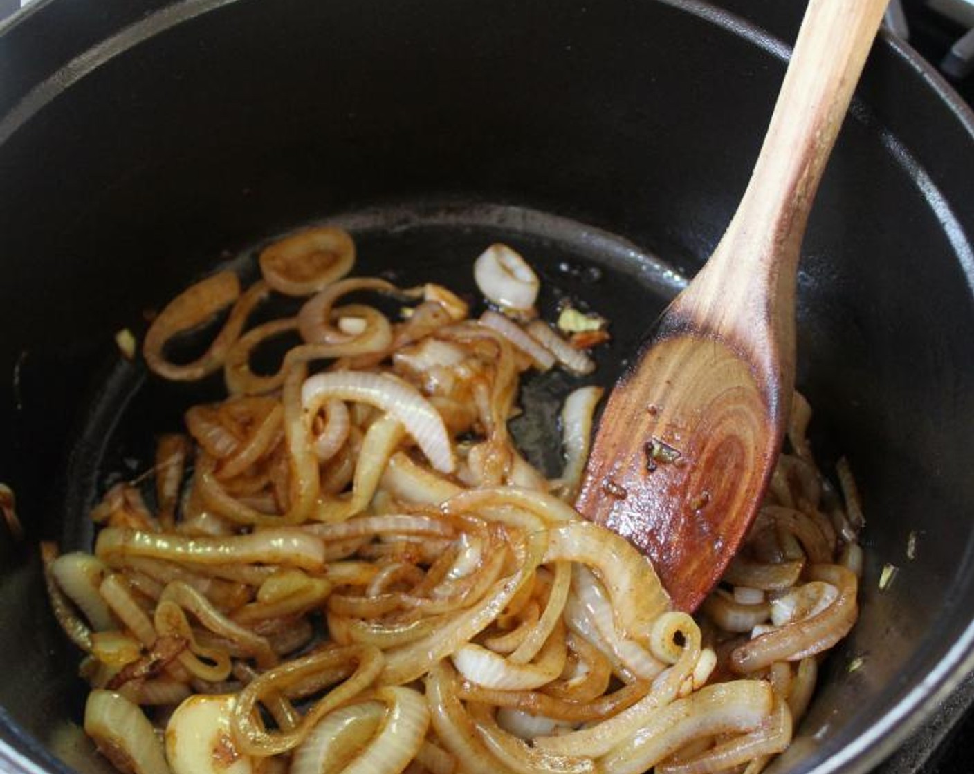 step 4 Meanwhile, drain any excess fat from the pot, leaving only a thin coating of oil on the bottom. (Or, if the pot looks dry, add a splash of olive oil.) Add the Vidalia Onion (1) and Garlic (3 cloves) and cook over medium-low heat for 10 minutes, until the onions are browned and translucent.