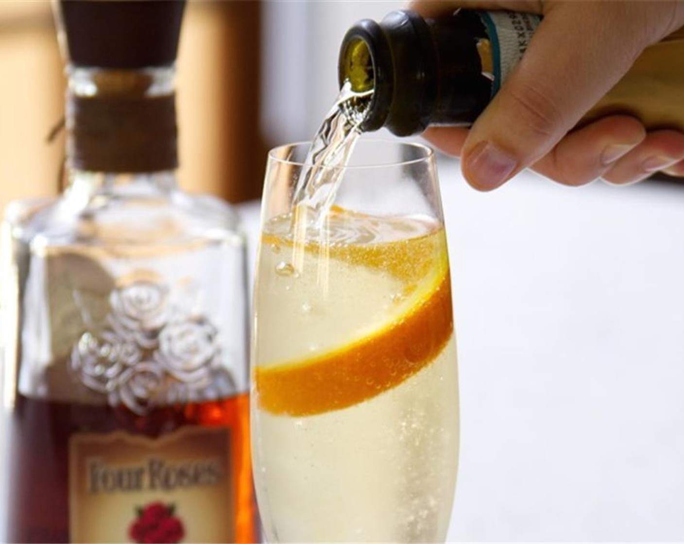 step 1 Pour just a splash of Four Roses Bourbon (1 splash) and Orange Liqueur (1 splash) into a champagne glass. Top off the glass with your favorite Prosecco Wine (to taste).
