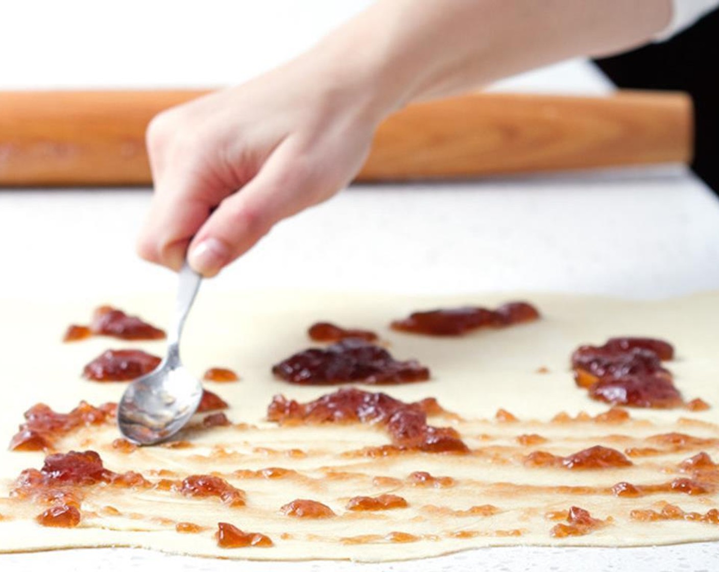 step 4 Spread the Just Jan’s® Pomegranate Fruit Spread (3/4 cup) evenly over the top of the pastry sheets.