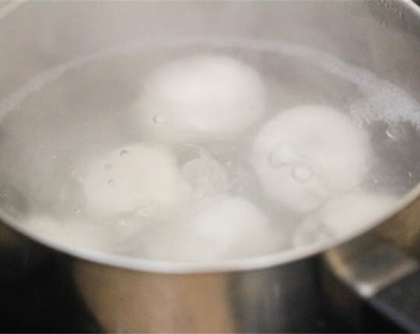 step 7 Put them in a large pot with water to cover them. Bring to a boil, and continue cooking for another 1-2 minutes after the tang yuans have floated to the surface.