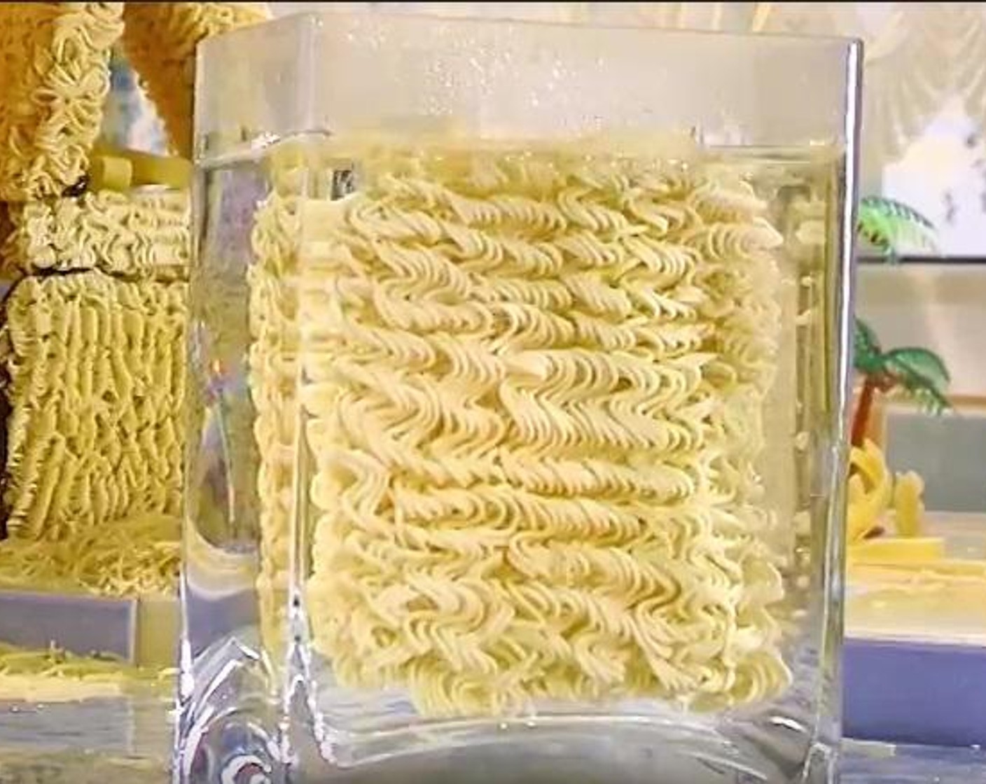 step 1 Take the Instant Noodles (3.5 oz) and put it inside a container with water, until it is well softened. When done, rinse the noodle using a pasta rinser.