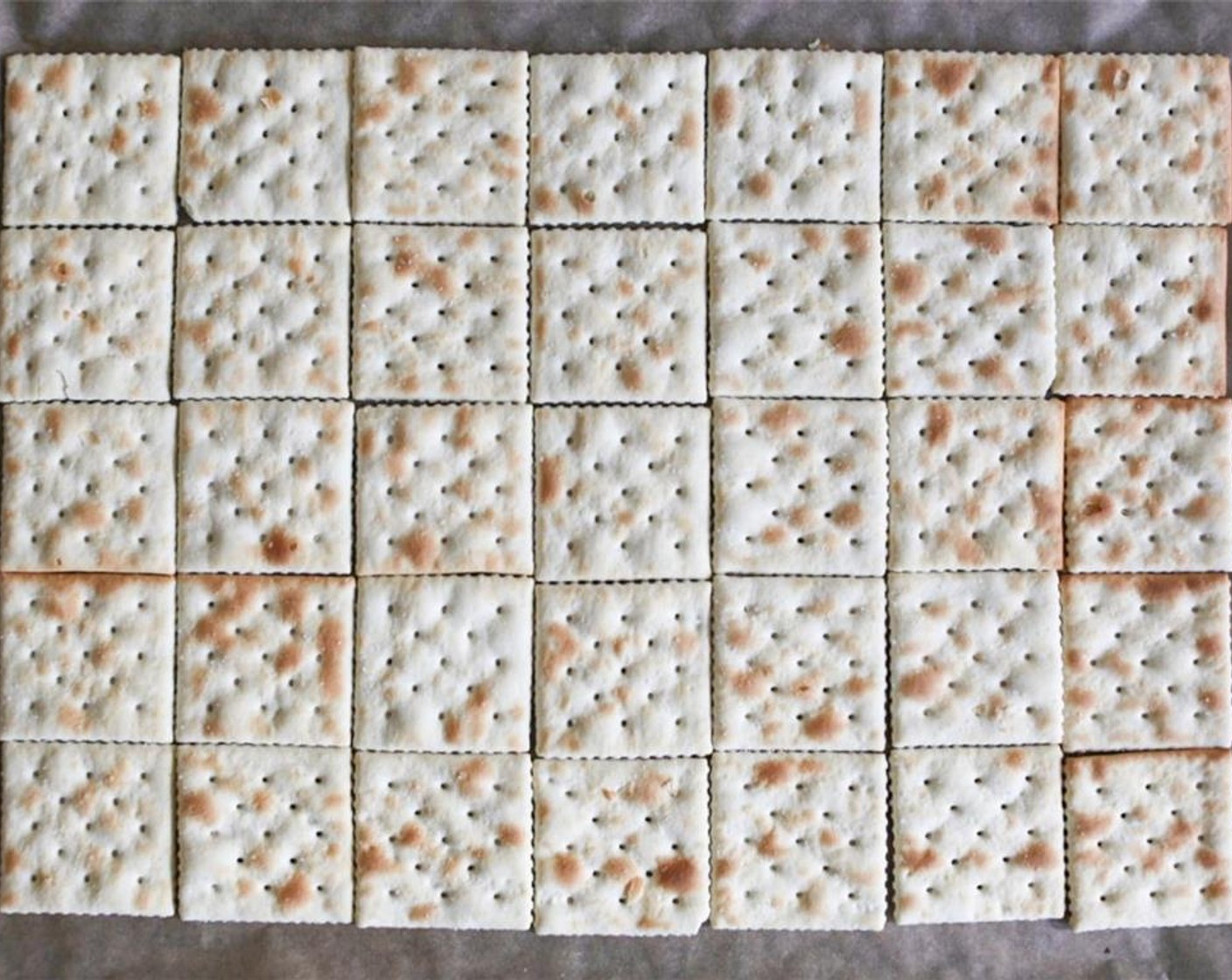 step 2 Arrange the Saltine Crackers (35) in a rectangle on the prepared baking sheet.