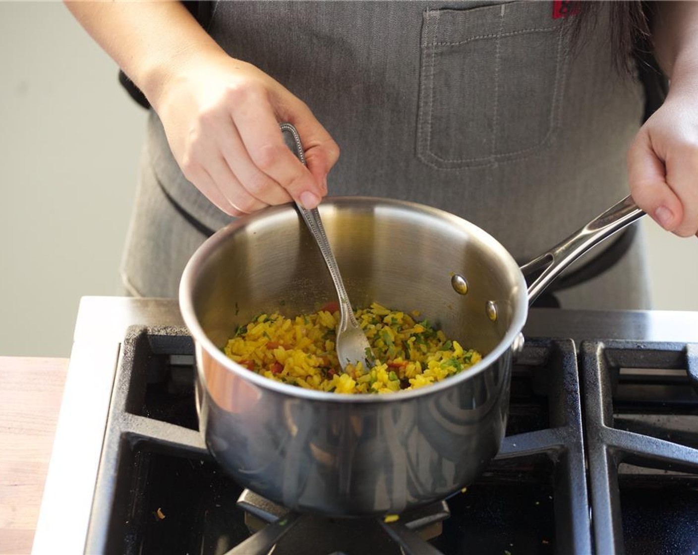 step 16 In a medium saucepan over medium high heat, add Vegetable Oil (1 Tbsp) Add the Jasmine Rice (3/4 cup), shallots, and chopped garlic, and cook for two minutes until golden.