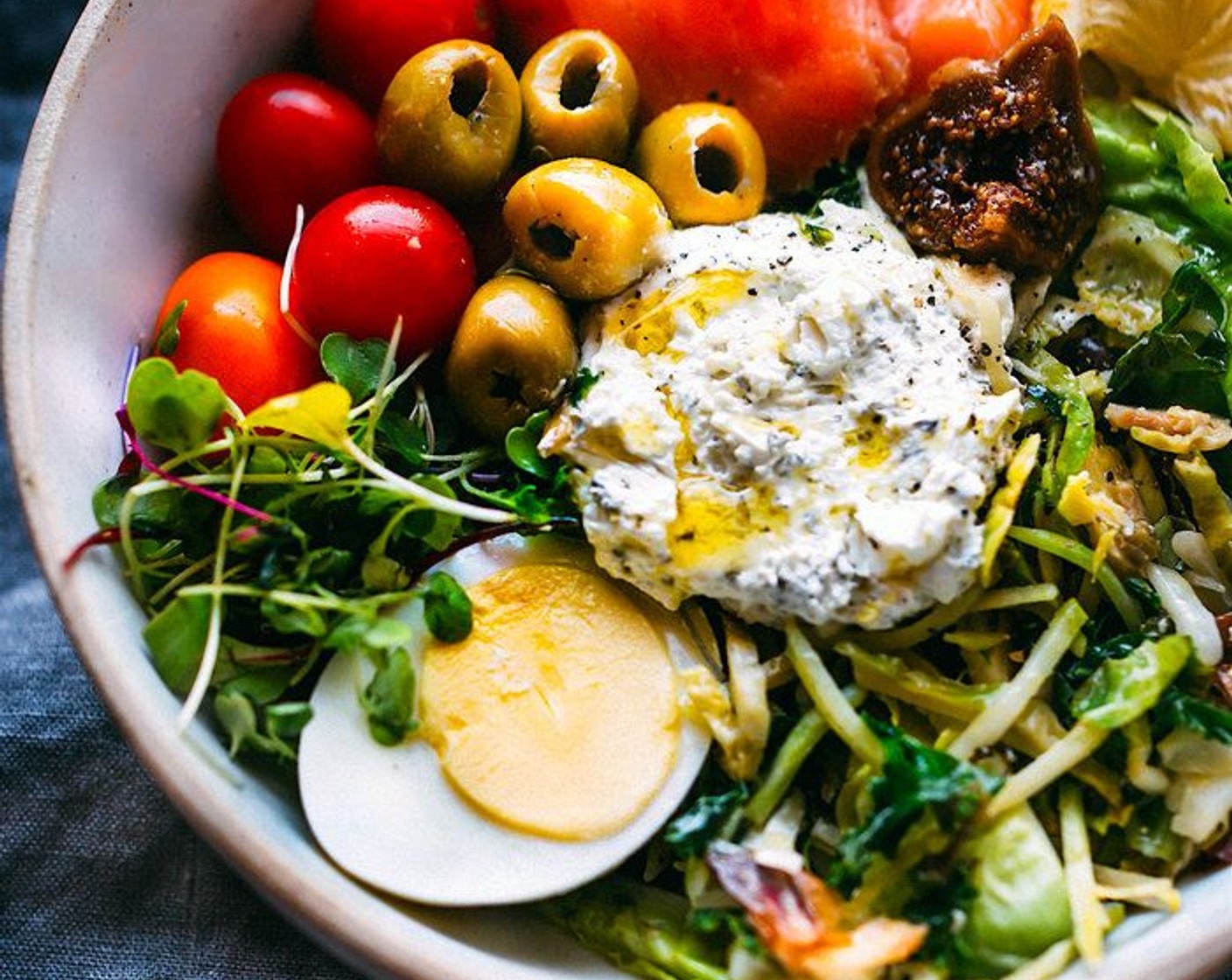 step 5 Divide steamed leafy greens, Cherry Tomato (1/2 cup), soft boiled eggs, Smoked Salmon (4 slices), Dried Figs (to taste), 2 tablespoons whipped goat cheese, and Roasted Almonds (to taste) into 2 bowls, equally. I like to section them out into different sides of the bowl.