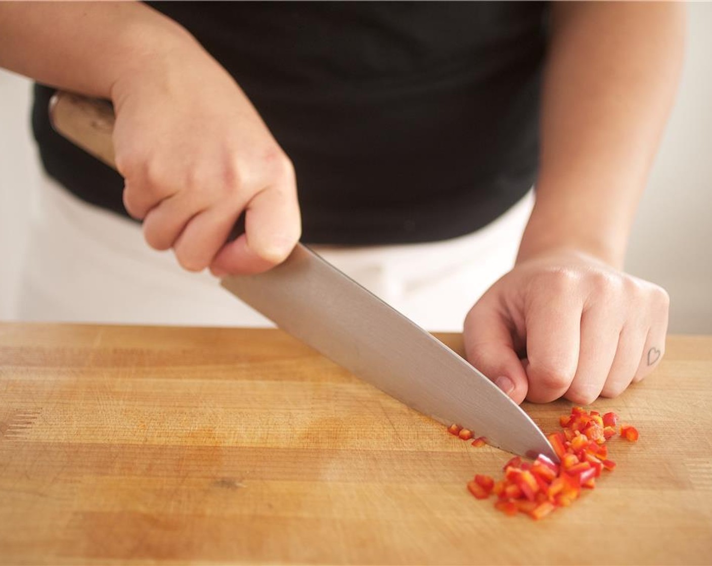 step 5 Slice the Red Fresno Chili Pepper (1) in half and remove the stem and seeds and discard. Chop the chili into 1/4 inch pieces. Slice green part of the Scallions (2 stalks) into 1/4 inch thin slices. Set aside.