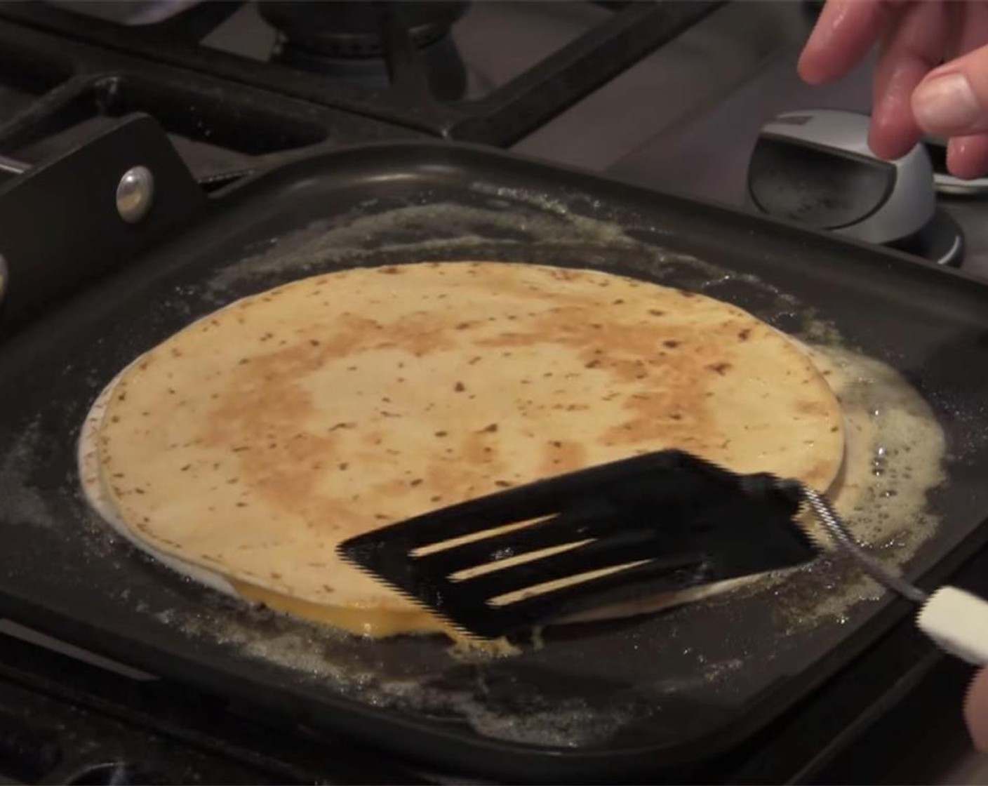 step 4 Add remaining Butter (1 Tbsp) to the top of the tortilla. Let cook for several minutes over low heat. As butter softens, spread over the top tortilla. Once bottom browns and cheese is mostly melted, flip the quesadilla over.