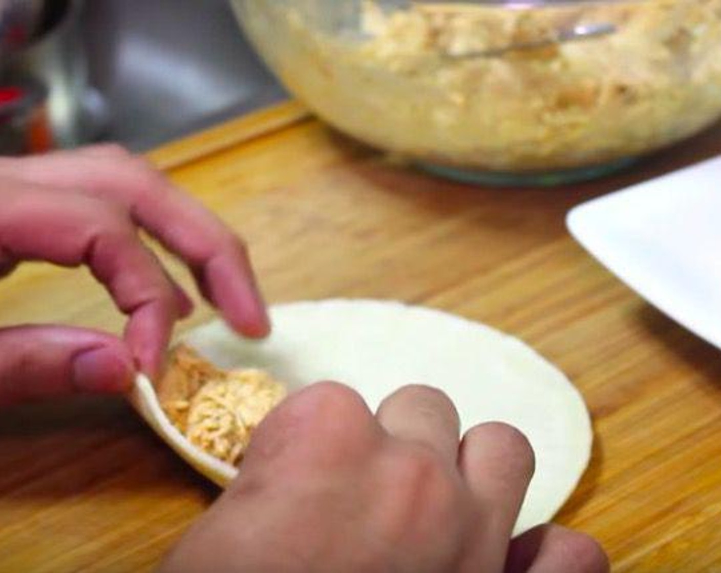 step 3 Take one tortilla and put some filling on. Roll it up nicely and tightly.