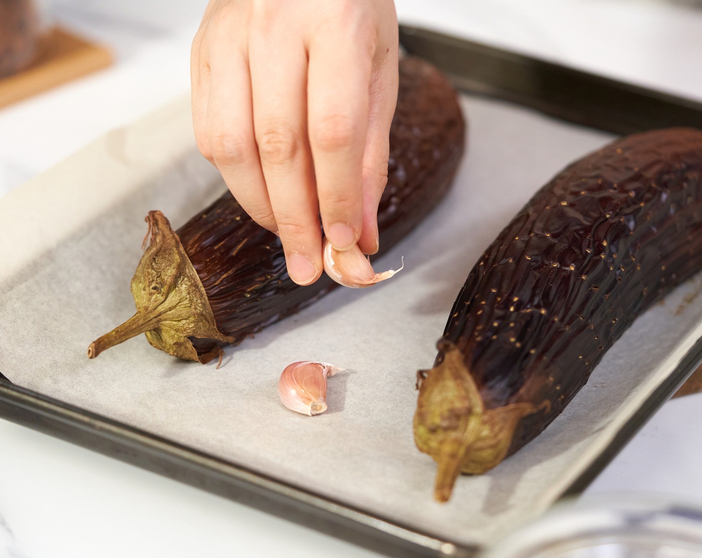 step 3 Remove the tray, add the Garlic (5 cloves) and continue roasting for 10-15 more minutes or until soft.