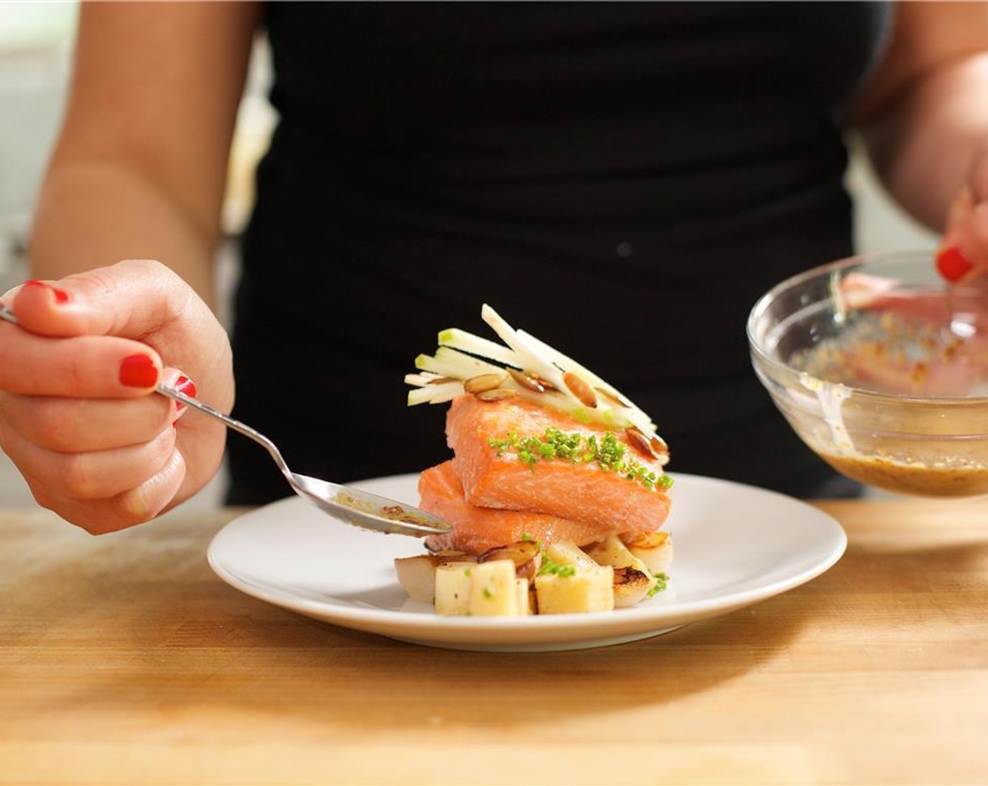 step 16 Arrange the parsnips and cipollini onion in a line down the center of two plates. Stack two pieces of ocean trout on top of the parsnips. Add the apple celery root salad on top of the fish. Sprinkle chives in a line down one edge of the top fillet.