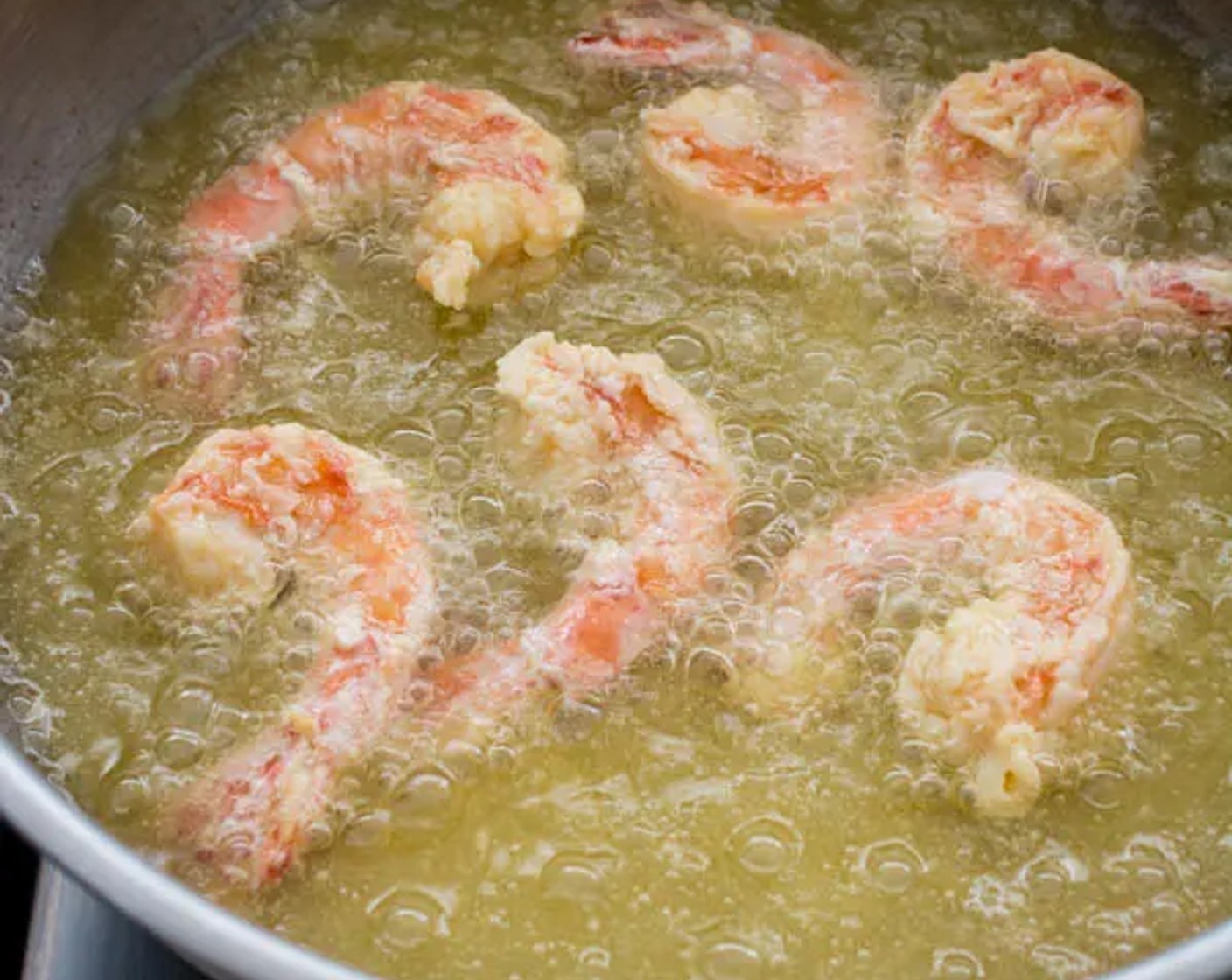 step 7 Fry the shrimp in small batches, shaking off the excess cornstarch as you carefully place each shrimp in the oil. Fry till the shrimp turn to a pale golden brown color for about 1-2 minutes per batch.