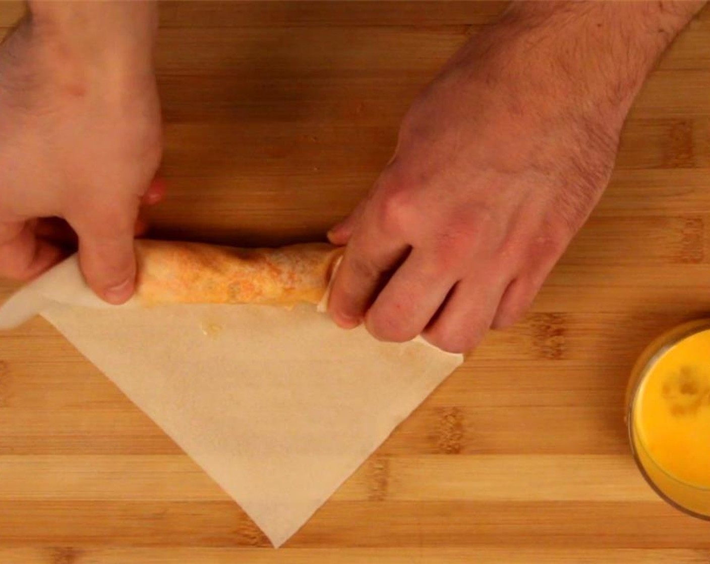 step 4 Roll the spring roll up, fold in sides, and secure the top corner with beaten egg.