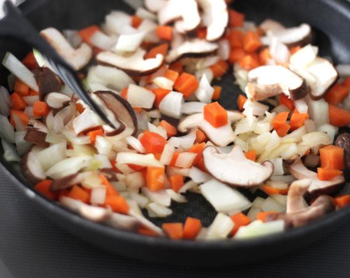 step 6 Add the onions, carrots, and mushrooms together with a pinch of salt and pepper. Wait until the onions turn light brown and the carrots become tender, it should be about 10 minutes.