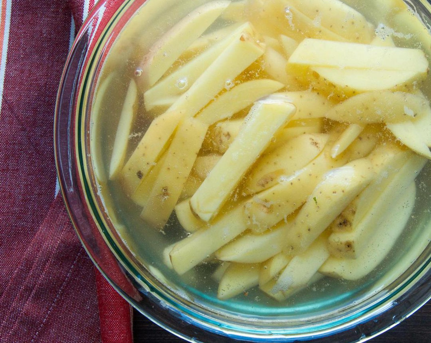 step 2 Swish the potatoes in the water with you hand and drain the water from the potatoes. Refill the bowl with cold water and rinse again.