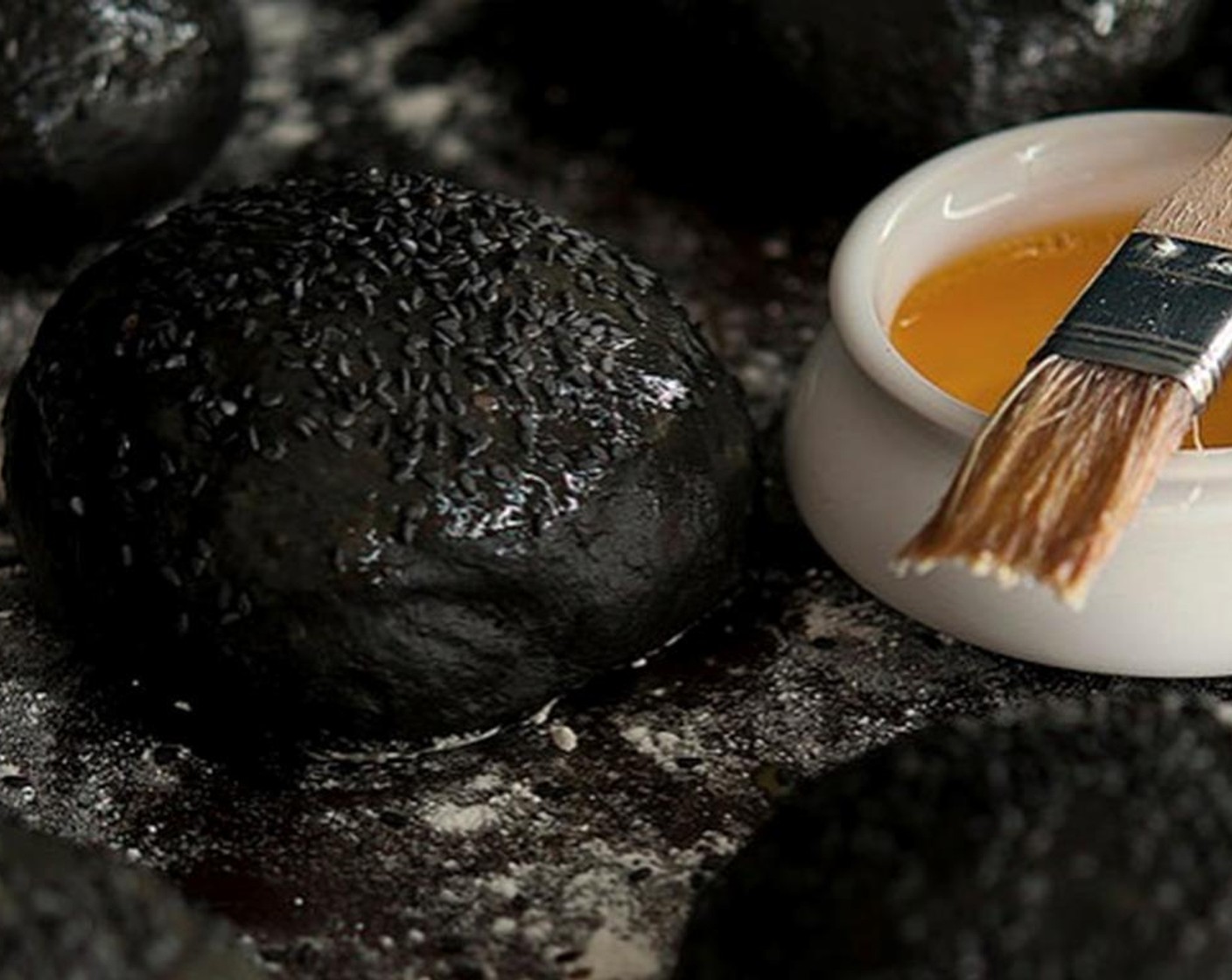 step 10 To make the egg wash, beat the remaining egg with a splash of water. When the buns are finished with the second rise, gently brush each one with egg wash. At this point, you could add Black Sesame Seeds (to taste) to the top of your rolls, if desired.