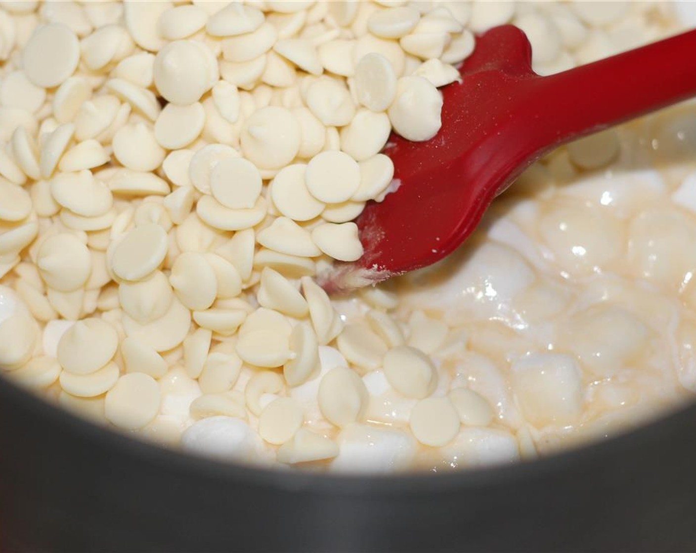 step 2 Remove heat and stir in Mini Marshmallows (1 2/3 cups), White Chocolate Chips (2 cups), Bailey's® Irish Cream (3 Tbsp), and Vanilla Extract (1 tsp). If mixture begins to harden, return to stove and heat on low until mixture is smooth.