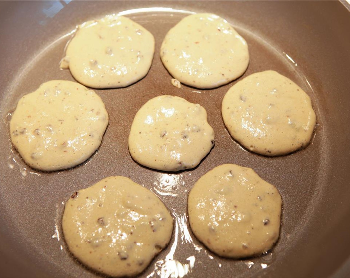 step 5 Blend to a smooth batter. Add Raisins (1 Tbsp) and mix well. Increase the heat slightly. Spoon 1 tablespoon of mixture at a time in the pan, filling up the pan. Cook for 1 minute, checking by lifting the sides of the pancake for browning.