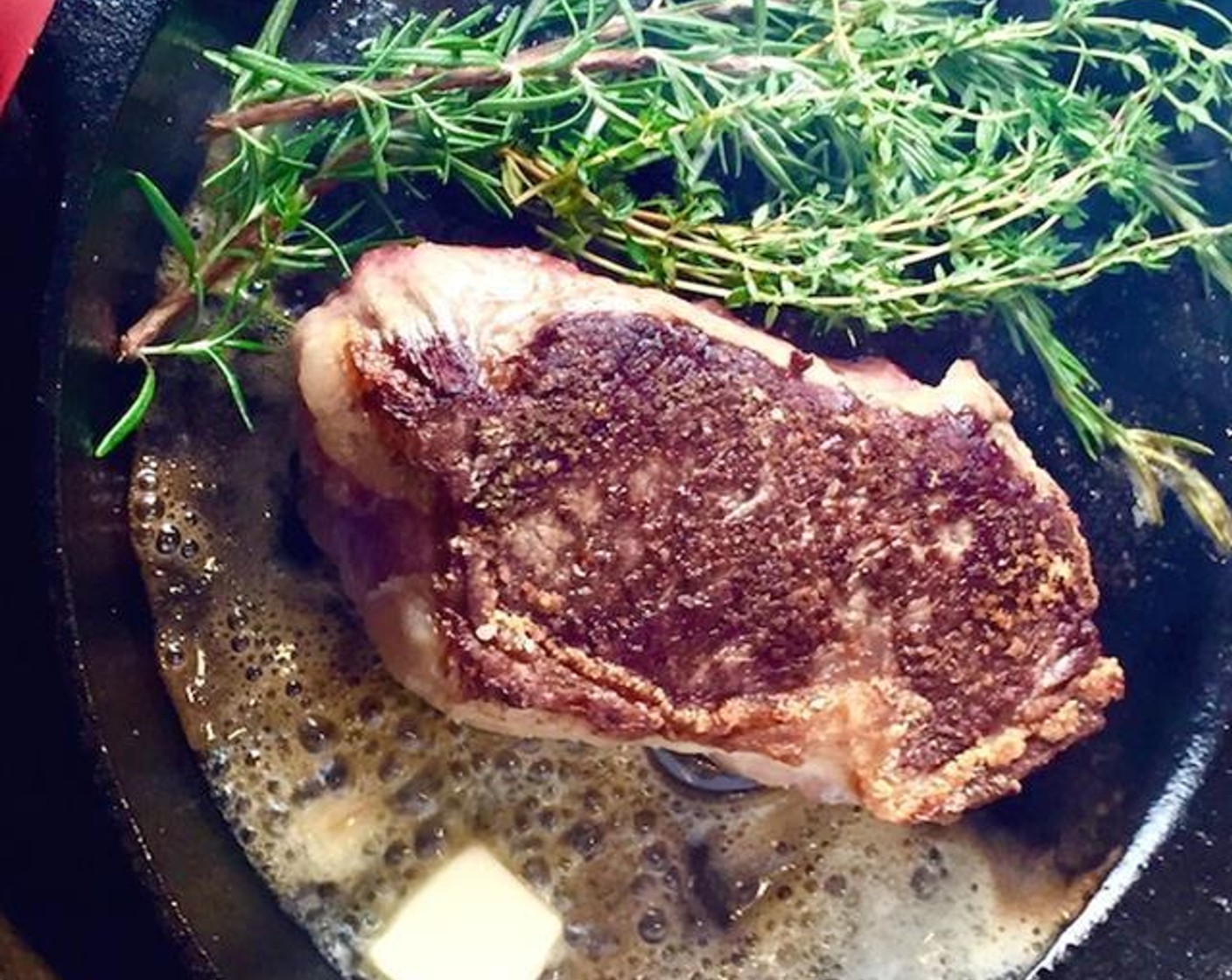 Cast Iron Seared Strip Steak with Herbs and Butter