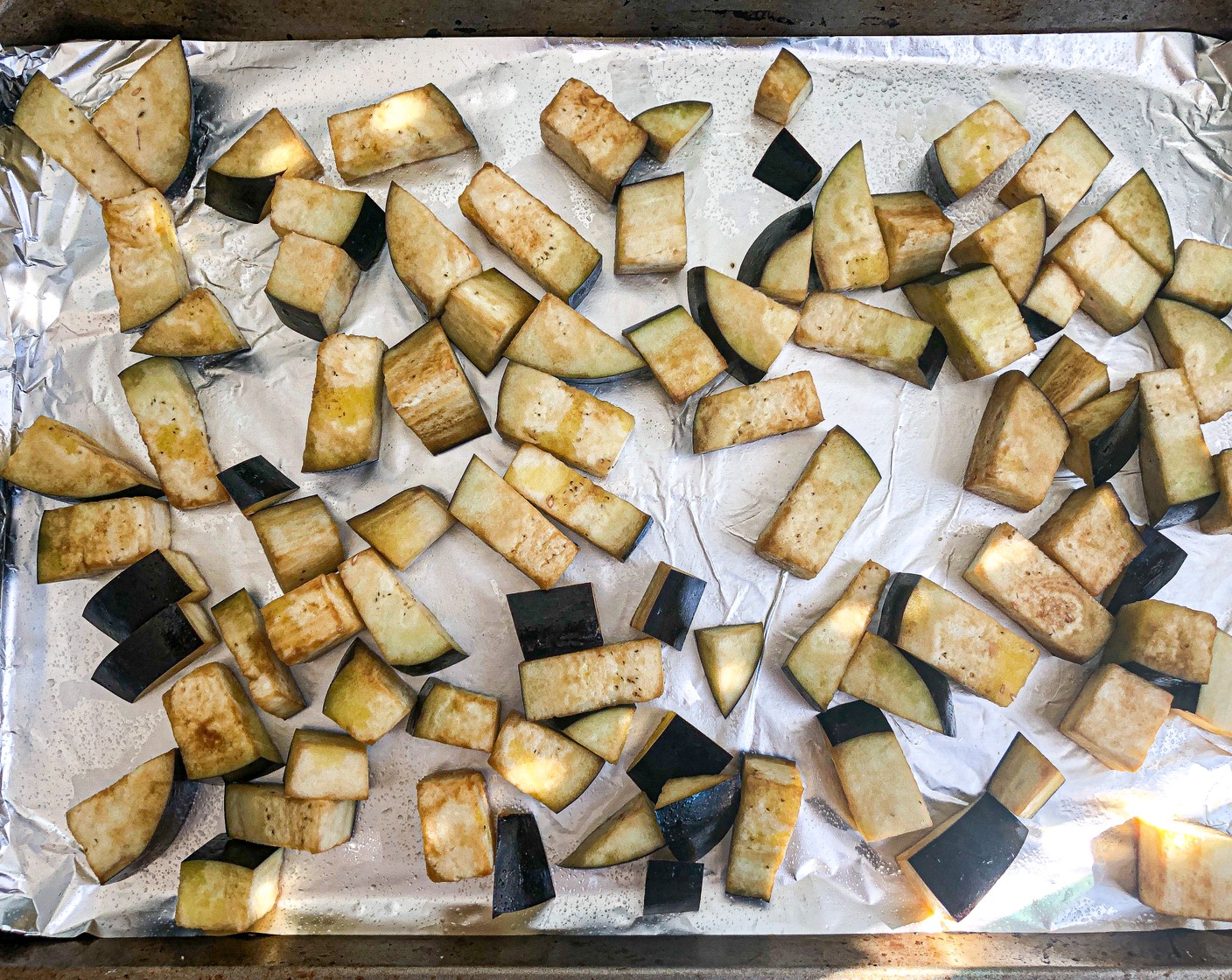 step 1 Preheat the oven to 450 degrees F (230 degrees C). Line a large baking sheet with foil and brush with 1 tablespoon Olive Oil (2 Tbsp). Place the Eggplant (1) in a large bowl and add 1 tablespoon of oil and Soy Sauce (1 Tbsp) and toss to coat.