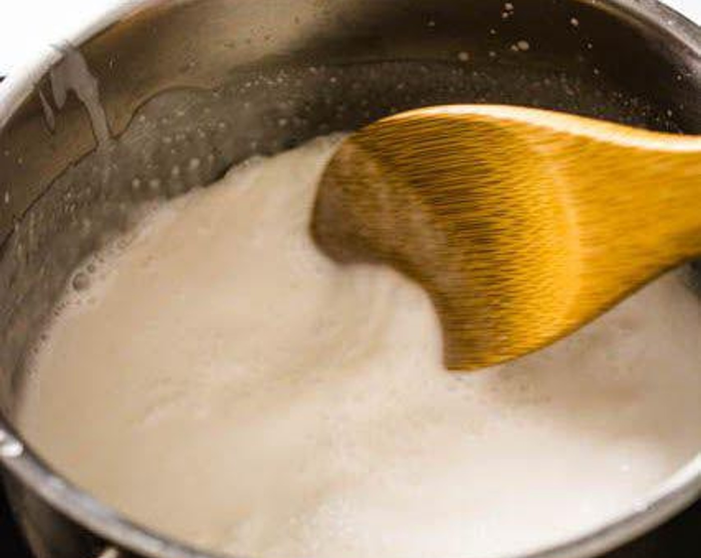 step 3 In a small saucepan or pot, heat Coconut Milk (1 cup) over medium heat. As it starts to boil, add the Palm Sugar (2 1/2 Tbsp) and Salt (1 pinch). Stir till the sugar and salt have dissolved. Set aside about 1/4 cup of the coconut milk mixture for serving later.