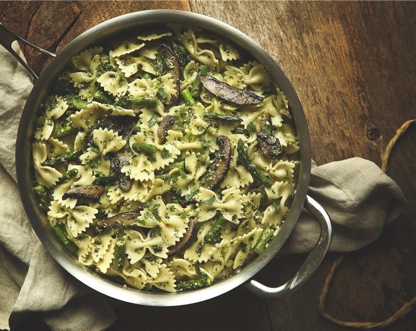 step 10 Add the farfalle to the saute pan. Fold in the pesto and reserved pasta water. Stir until well combined.