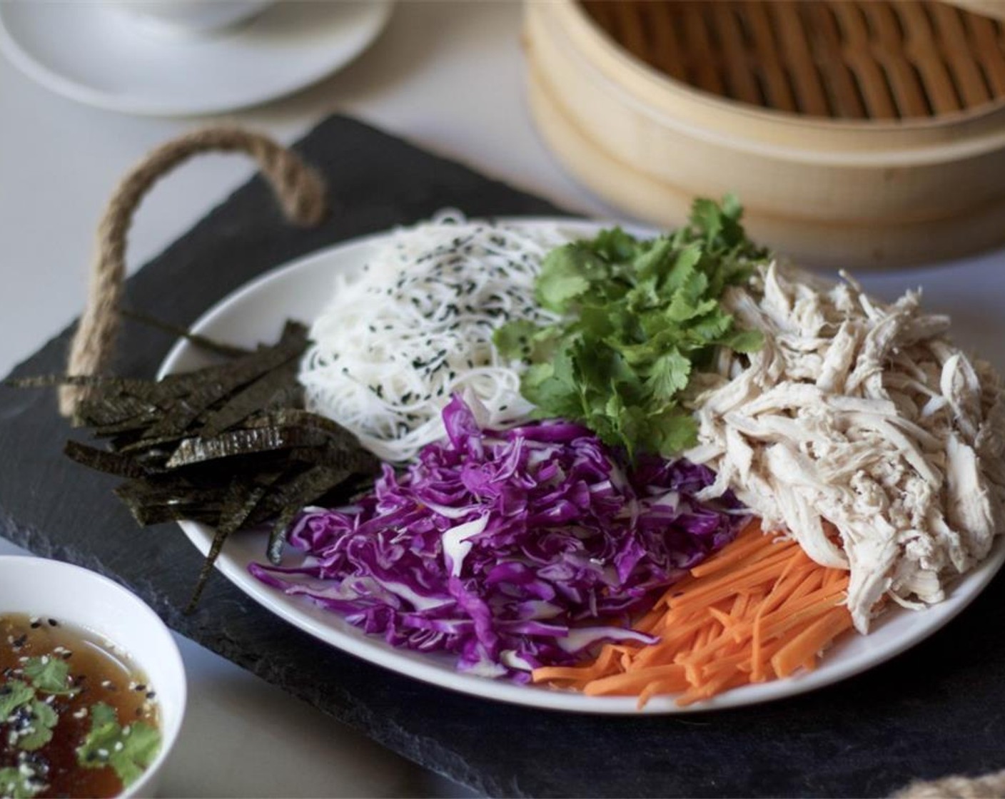 step 4 Arrange the Red Cabbage (1), Carrots (2), Nori Sheets (2), Red Chili Pepper (1), Rice Noodles (1 handful), and shredded chicken on a board, ready at hand.