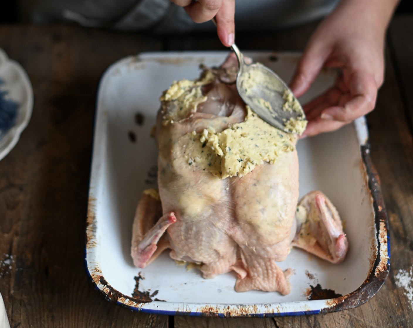 step 4 Using your fingers, rub the garlic anchovy butter all over the chicken. Use a blunt-bladed knife to loosen the skin over the breast and push the butter into the pocket as this ensures a juicy roast.