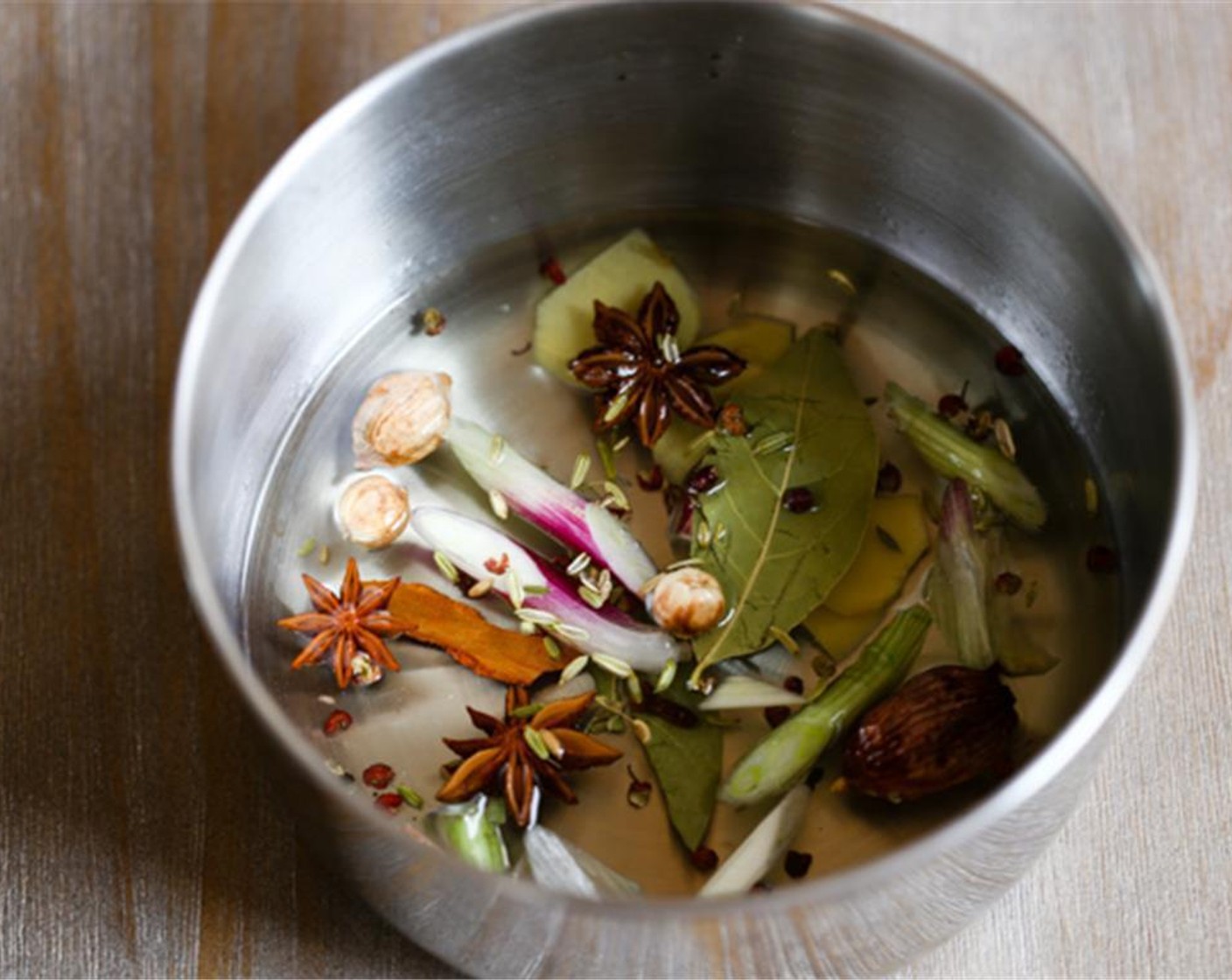 step 1 Heat Fresh Ginger (1 piece), Bay Leaves (2), Star Anise (3), Chinese Cinnamon Bark (1), white part of Scallion (1 bunch), Sichuan Peppercorns (1/4 tsp), Garlic (4 cloves), Cumin Seeds (1/4 tsp) in Vegetable Oil (1 cup) over the slowest fire for around 5 minutes.