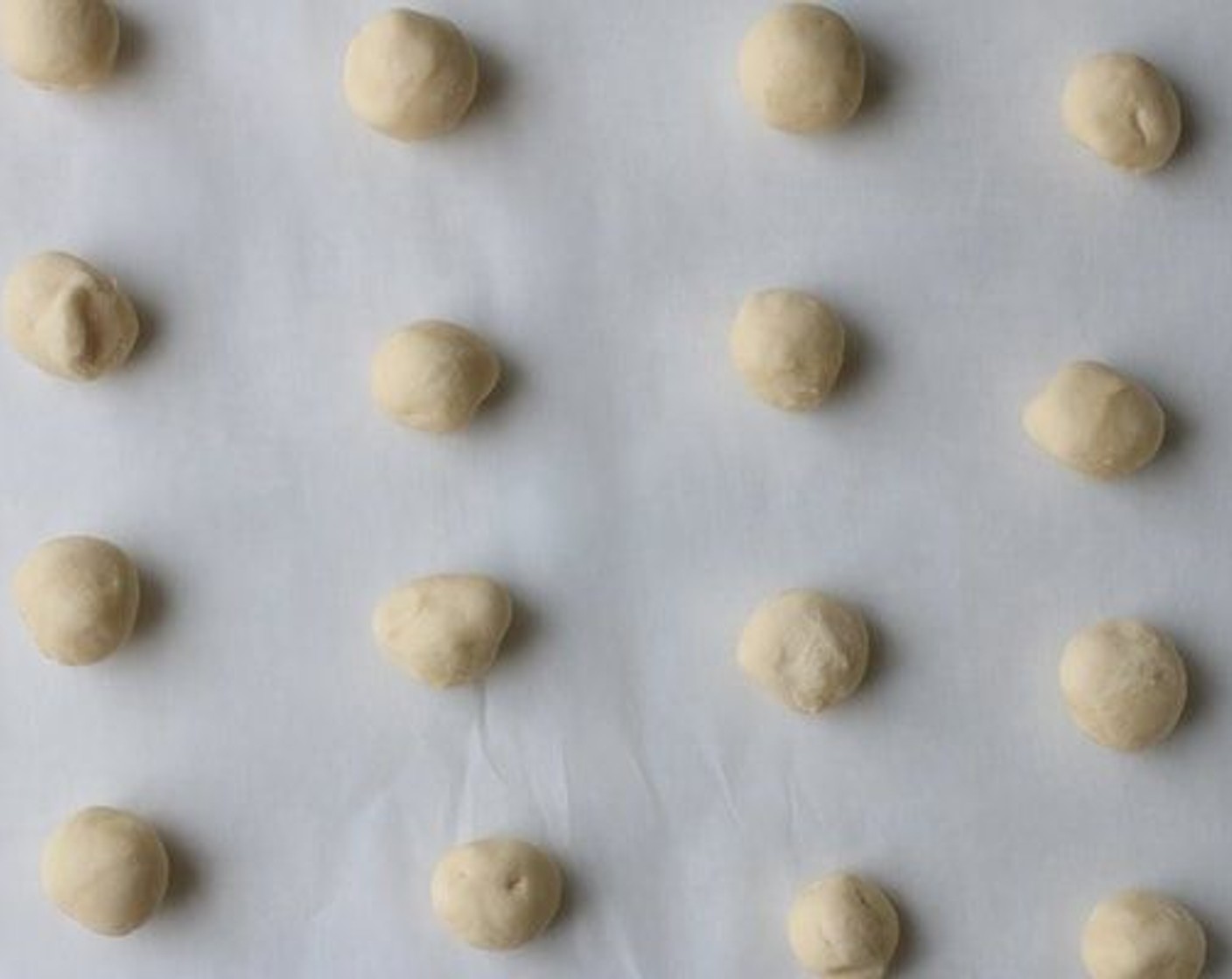 step 5 Scoop out 1 tablespoon of dough at a time, roll into balls and space evenly about 2 inches apart on prepared baking sheets.