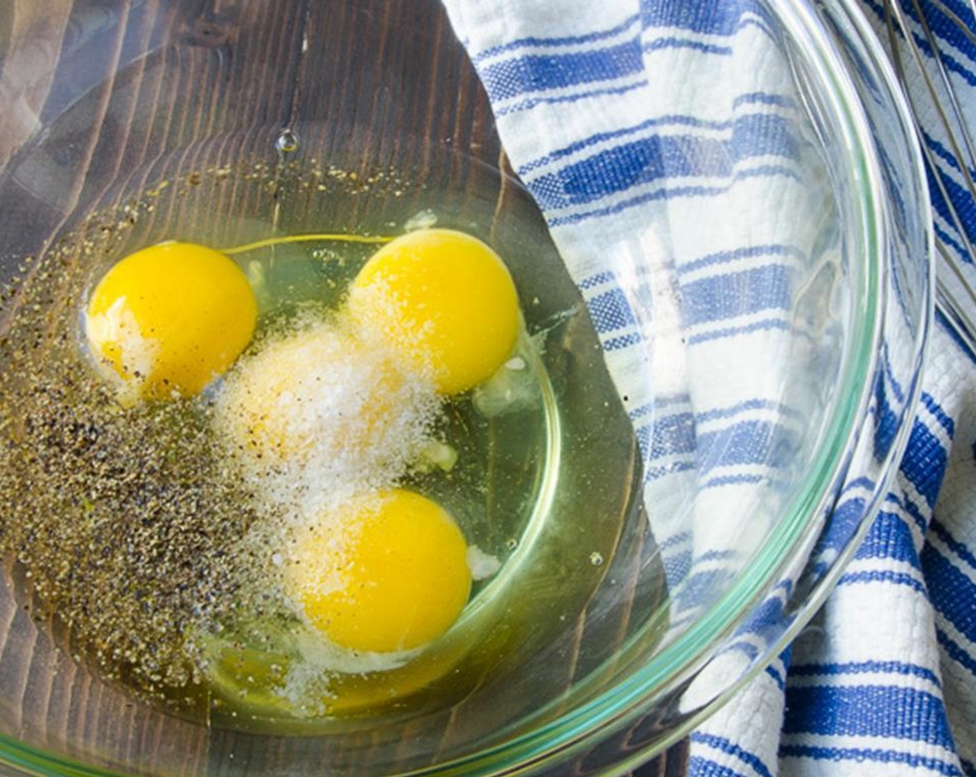 step 8 Meanwhile crack the Eggs (4) into a large bowl. Add Kosher Salt (1/2 tsp) and Freshly Ground Black Pepper (1/4 tsp) and whisk to combine.