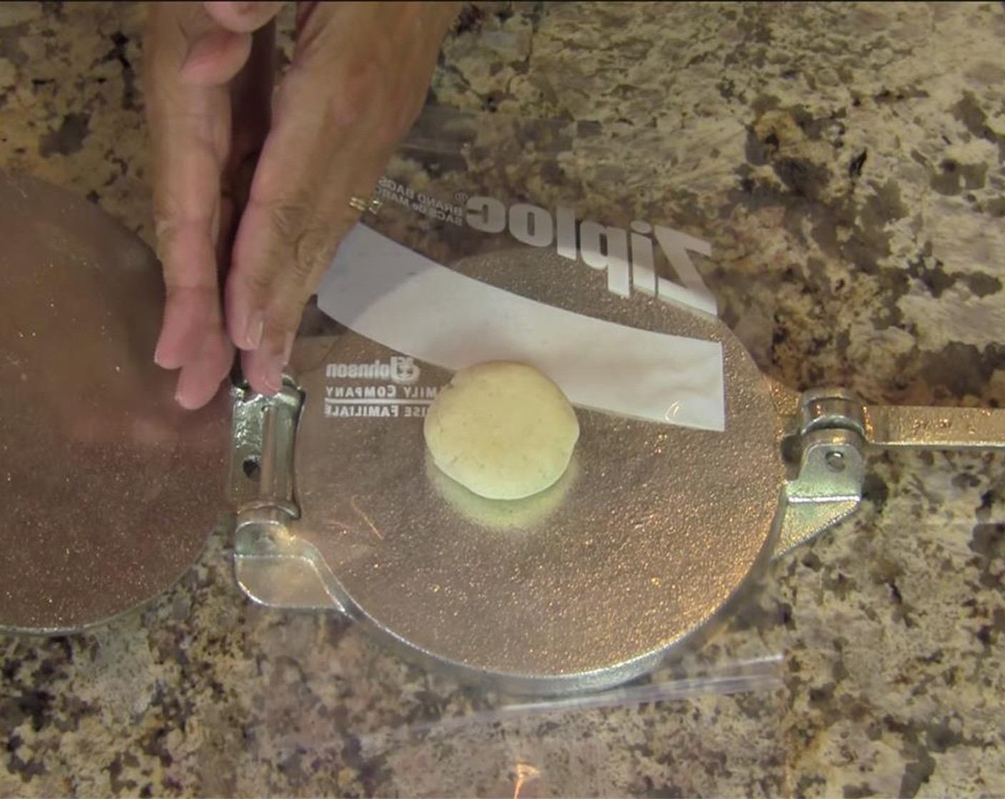 step 5 Roll a golf ball sized ball of dough into a ball. Line the tortilla press with the plastic bag, and open the bag. Slightly flatten the ball, and place between the plastic on the press, slightly off centered, closer to the hinge side.