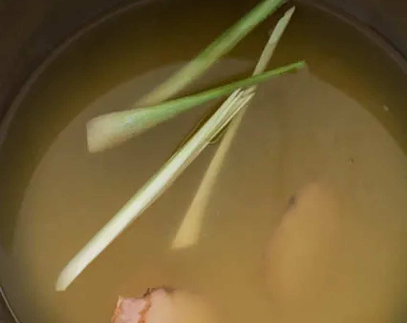 step 1 Pour Chicken Stock (4 cups) into a medium-sized pot or saucepan. Add Lemongrass (2 stalks) and Galangal (3 slices) to the chicken stock, then bring it to a boil over medium-high heat.
