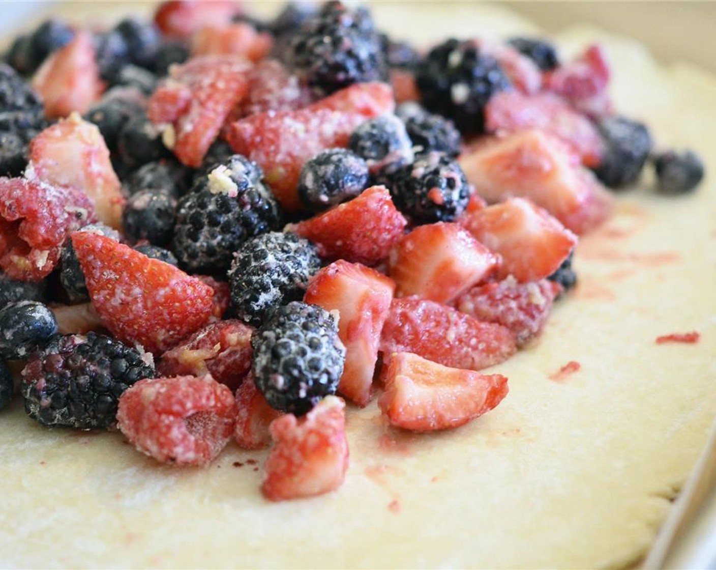 step 7 Remove rolled out pie crust from fridge and pile berries high into the center of the crust leaving a 2-inch​ border for the crust.