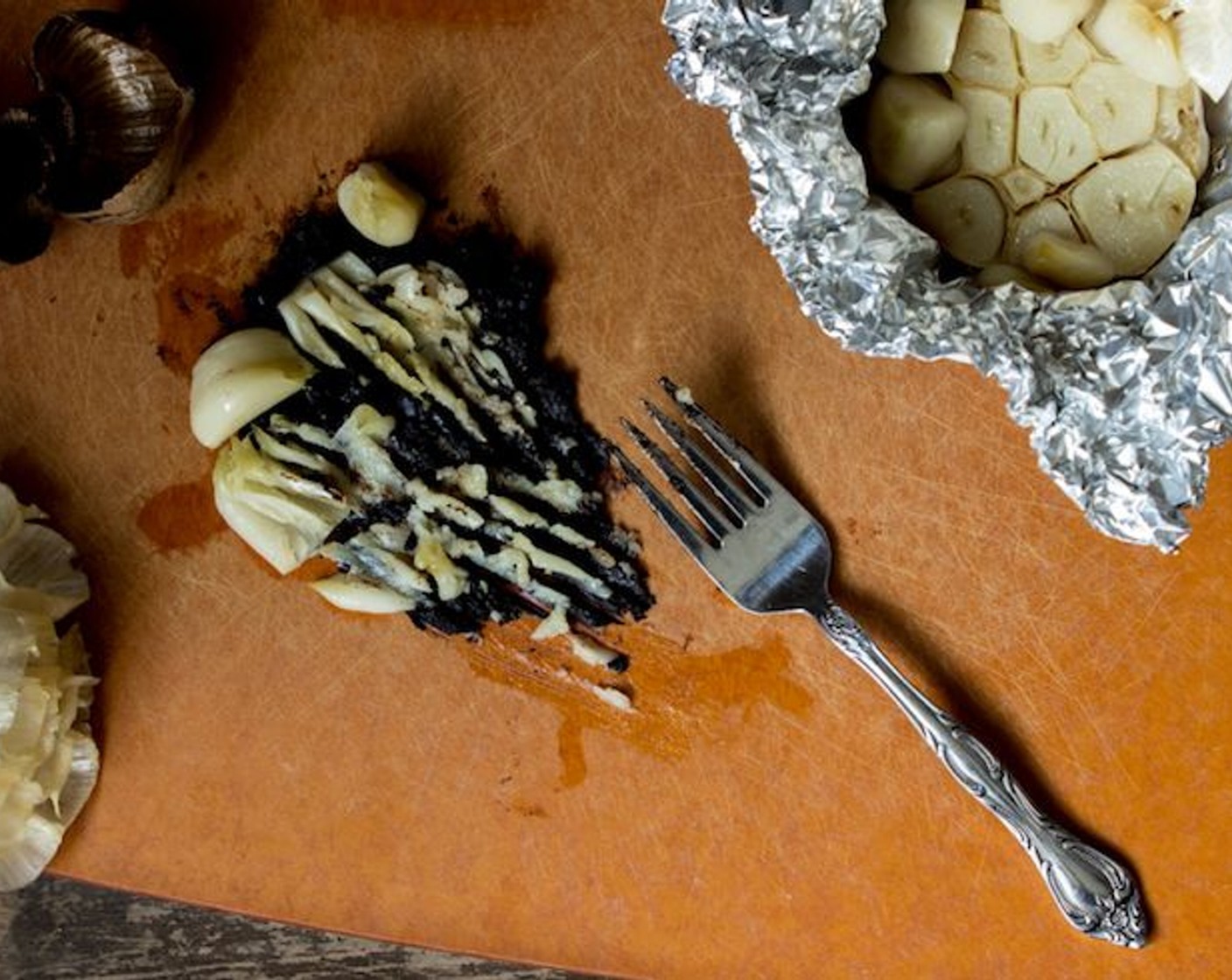 step 12 With a fork, mash the black garlic and roasted garlic together.