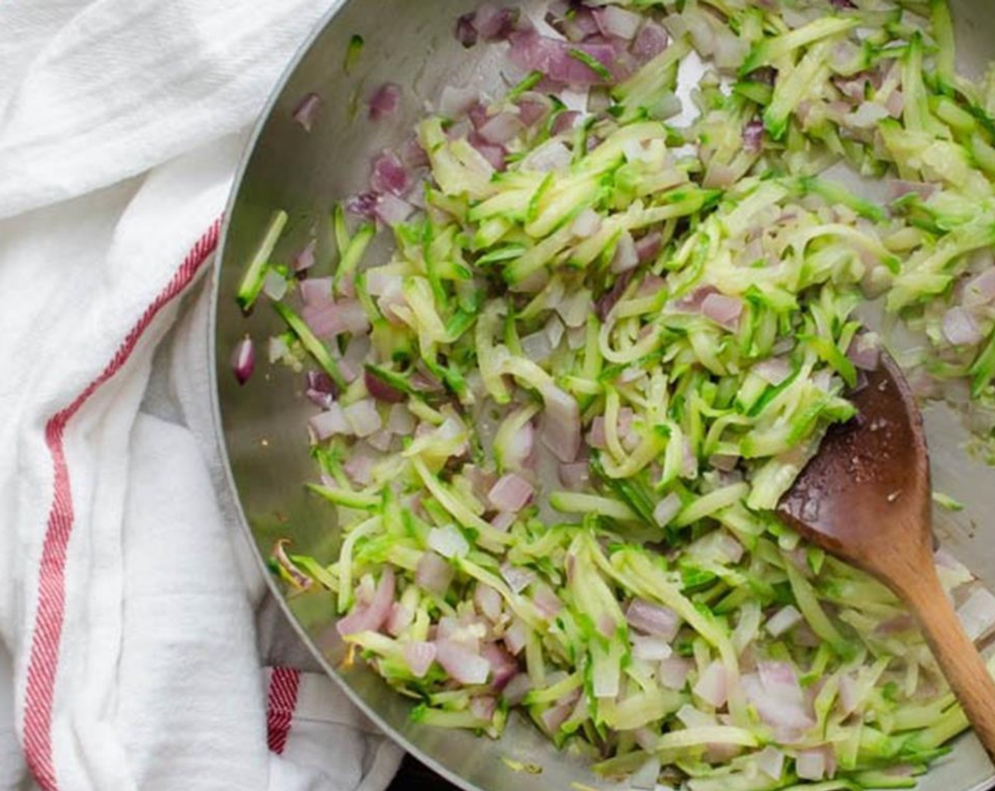 step 4 In a large skillet over medium high heat, add Olive Oil (1 Tbsp). When the oil is hot, add Onion (1 cup), Zucchini (1), and Garlic (2 cloves). Cook until softened, 3-5 minutes. Transfer mixture to a small bowl.