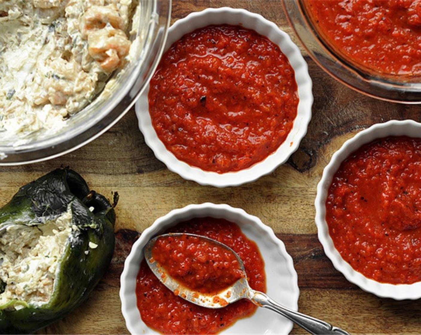 step 14 Spoon the red bell peppers sauce onto the bottom of a 9×13 inch baking dish or 6 individual serving dishes. Place the stuffed peppers on top of the sauce. Bake for 40 minutes on a baking sheet lined with foil to catch any drippings.