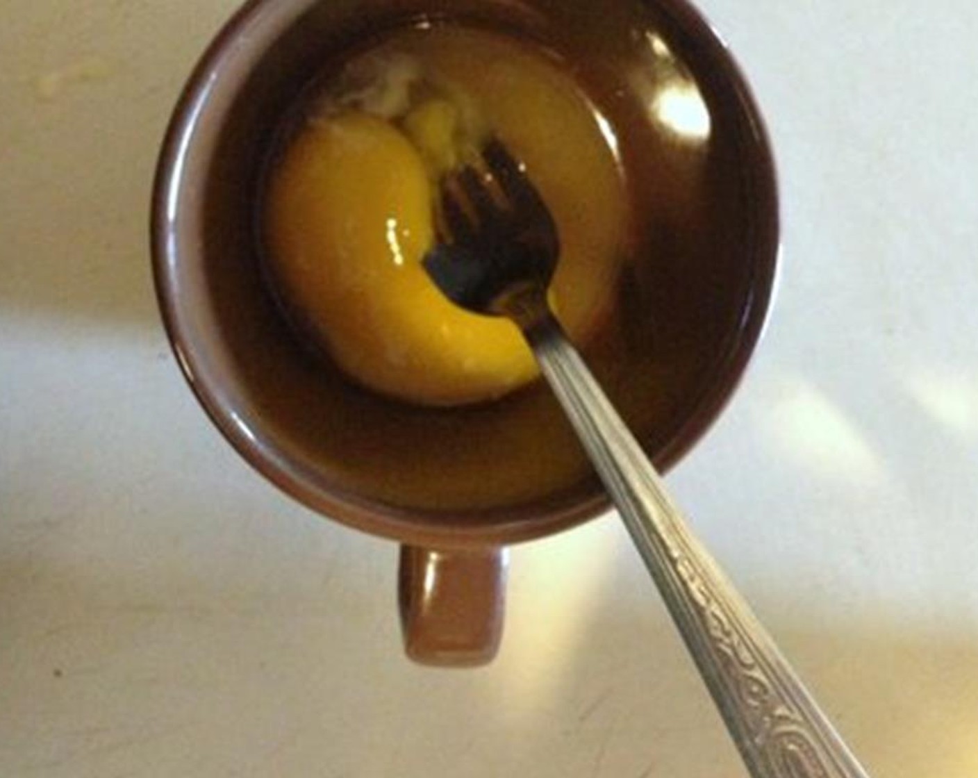 step 3 Add the yolk of the Eggland's Best Classic Egg (1) the cup and mix until combined.