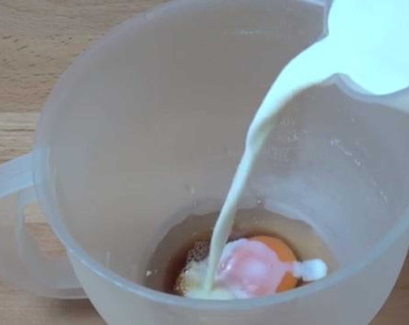 step 2 In a mixing jug, whisk together the Egg (1),  Vanilla Extract (1/2 Tbsp), and Milk (3/4 cup).