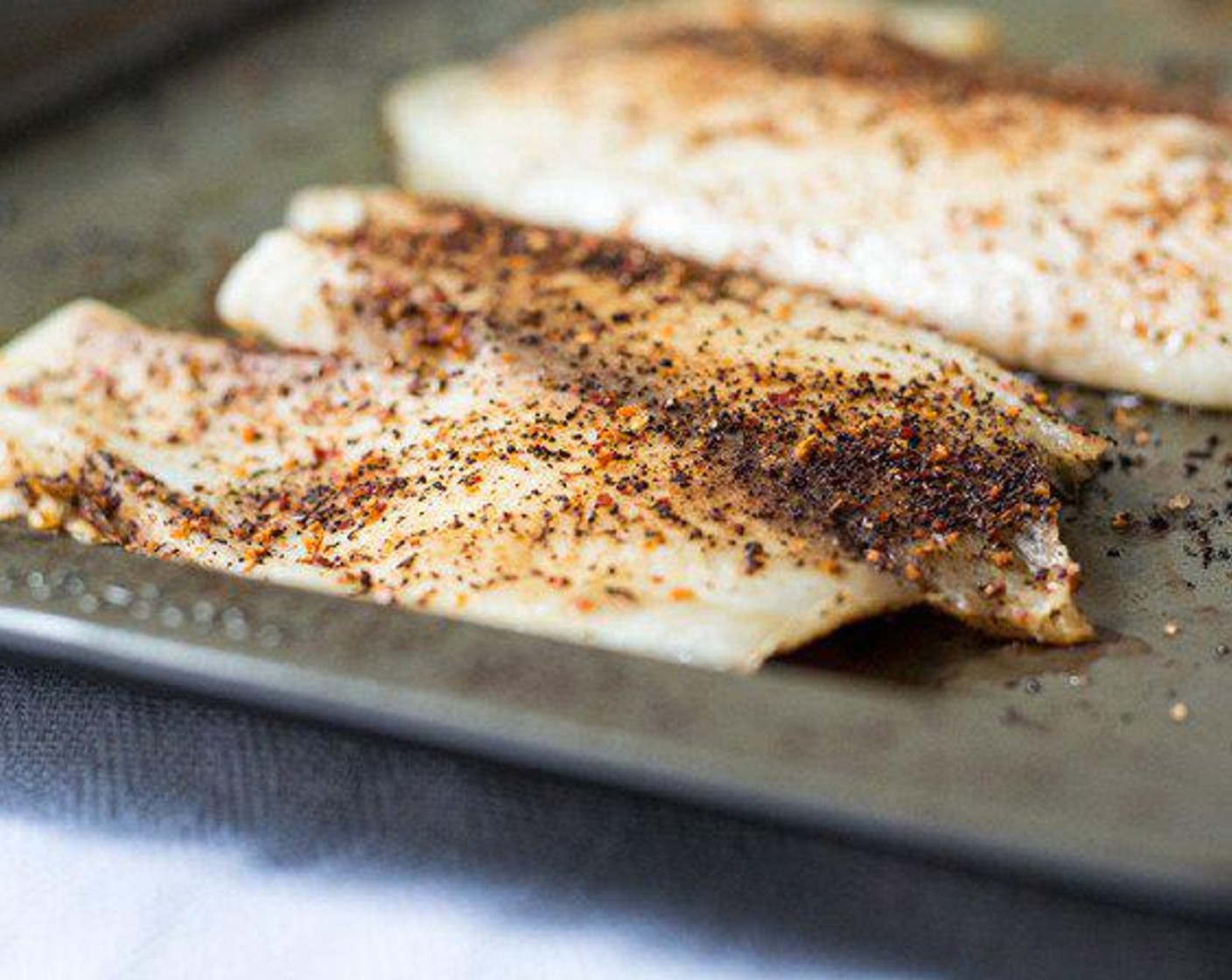 step 4 Bake for 9 minutes, remove pan and flip both tilapia fillets as well as sweet potato cubes.